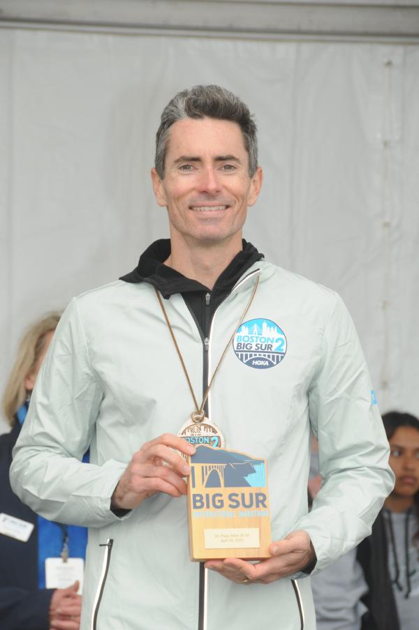 A photo of Chris holding his age group award