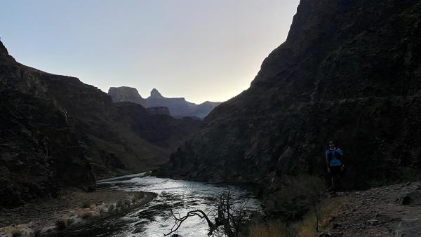 A picture of Chris alongisde the Colorado River in the early morning light