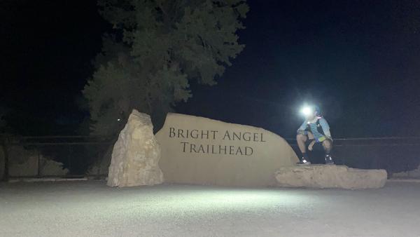 Chris crouches near the Bright Angel Trail trailhead