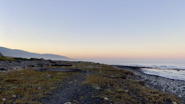 A colorful sunset sky over a remote coast