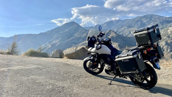 A motorcycle parked along a mountain road